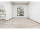 Living room featuring a large arched window and beige carpeting at 4920 E Beryl Ave, Paradise Valley, AZ 85253