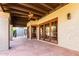 Covered patio with flagstone flooring and wooden doors at 4920 E Beryl Ave, Paradise Valley, AZ 85253