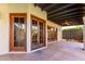 Covered patio with flagstone flooring and wooden doors at 4920 E Beryl Ave, Paradise Valley, AZ 85253