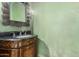 Elegant powder room with dark wood vanity and green walls at 4920 E Beryl Ave, Paradise Valley, AZ 85253