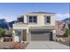 Two-story house with a gray garage door and desert landscaping at 5132 E Umber Rd, San Tan Valley, AZ 85143