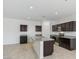 Modern kitchen with island, dark cabinets and granite countertops at 5132 E Umber Rd, San Tan Valley, AZ 85143