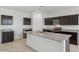 Modern kitchen with dark brown cabinets, granite countertops, and island at 5132 E Umber Rd, San Tan Valley, AZ 85143