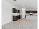 Modern kitchen with dark cabinetry, granite counters, and a large island at 5132 E Umber Rd, San Tan Valley, AZ 85143