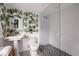 Modern bathroom with fig leaf wallpaper and a glass shower at 5328 N 46Th St, Phoenix, AZ 85018