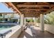 Covered patio with string lights, pool view, and cornhole at 5328 N 46Th St, Phoenix, AZ 85018