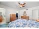 Bright bedroom with floral bedding, dresser, and ceiling fan at 5415 N 79Th Dr, Glendale, AZ 85303