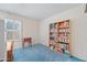 Bedroom with bookcase, small table, and blue carpet at 5415 N 79Th Dr, Glendale, AZ 85303