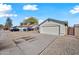 Attached garage with a white door and gravel driveway at 5415 N 79Th Dr, Glendale, AZ 85303