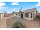 Back exterior view of house with gravel yard and fence at 5415 N 79Th Dr, Glendale, AZ 85303