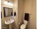 Small bathroom with pedestal sink and toilet at 5744 W Siesta Way, Laveen, AZ 85339