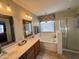 Bathroom boasts double sinks, a soaking tub, and separate shower at 5744 W Siesta Way, Laveen, AZ 85339