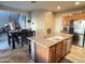 Kitchen with island, stainless steel appliances, and view into dining area at 5744 W Siesta Way, Laveen, AZ 85339