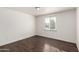 Simple bedroom with wood floors and a window at 5932 W Holly St, Phoenix, AZ 85035