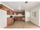 Cozy kitchen featuring wood cabinets and tile flooring at 5932 W Holly St, Phoenix, AZ 85035