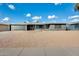 House exterior featuring gray brick, modern garage door, and desert landscaping at 6702 E Adobe St, Mesa, AZ 85205