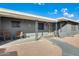 Front porch with gray brick, decorative columns, and wooden chairs at 6702 E Adobe St, Mesa, AZ 85205