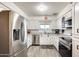 Bright kitchen featuring stainless steel appliances and white cabinets at 6702 E Adobe St, Mesa, AZ 85205