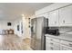 Kitchen features stainless steel refrigerator and white cabinets at 6702 E Adobe St, Mesa, AZ 85205