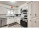 Bright kitchen with stainless steel appliances and white cabinets at 6702 E Adobe St, Mesa, AZ 85205