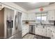 Stainless steel appliances and white cabinets in this kitchen at 6702 E Adobe St, Mesa, AZ 85205