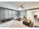 Living room with sectional sofa, coffee table, and ceiling fan at 6702 E Adobe St, Mesa, AZ 85205