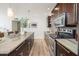 Modern kitchen with dark wood cabinets and granite countertops at 6805 E 2Nd St # 17, Scottsdale, AZ 85251