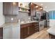 Modern kitchen with dark wood cabinets, granite counters, and stainless steel appliances at 6805 E 2Nd St # 17, Scottsdale, AZ 85251