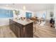 Modern kitchen island with seating overlooking living room at 6805 E 2Nd St # 17, Scottsdale, AZ 85251