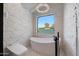 Spa-like bathroom with a freestanding tub and a large window at 6912 E Larkspur Dr, Scottsdale, AZ 85254