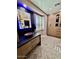 Modern bathroom with a copper sink, blue LED lighting, and herringbone floors at 6912 E Larkspur Dr, Scottsdale, AZ 85254