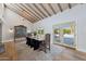 Elegant dining room features a rustic wood table and exposed beam ceiling at 6912 E Larkspur Dr, Scottsdale, AZ 85254