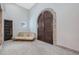 Unique entryway with brick floors, a rustic bench, and large wood door at 6912 E Larkspur Dr, Scottsdale, AZ 85254