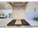 Modern gas cooktop with stainless steel range hood at 6912 E Larkspur Dr, Scottsdale, AZ 85254