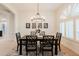 Formal dining area with chandelier, dark wood table, and neutral wall decor at 747 E Nolan Pl, Chandler, AZ 85249