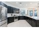 Modern kitchen featuring dark cabinetry and a large island at 747 E Nolan Pl, Chandler, AZ 85249