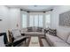 Cozy living room with neutral-toned furniture and a charming window seat at 747 E Nolan Pl, Chandler, AZ 85249