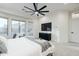 Main bedroom with large windows, mounted TV, and ceiling fan at 747 E Nolan Pl, Chandler, AZ 85249