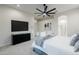 Main bedroom with large windows, mounted TV, and ensuite bathroom at 747 E Nolan Pl, Chandler, AZ 85249