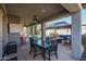 Covered patio features dining table and comfortable seating at 7934 W Andrea Dr, Peoria, AZ 85383