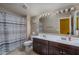 Bathroom boasts double sinks and a striped shower curtain at 7934 W Andrea Dr, Peoria, AZ 85383