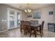 Bright dining room with wooden table and chairs, and access to backyard at 7934 W Andrea Dr, Peoria, AZ 85383