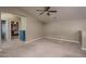 Spacious loft area with neutral carpeting and ceiling fan at 7934 W Andrea Dr, Peoria, AZ 85383