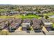 Aerial view of homes with tile roofs near a scenic green golf course and lake at 8243 E Cortez Dr, Scottsdale, AZ 85260