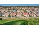 Aerial view of desert homes and a golf course from afar with mountain views at 8243 E Cortez Dr, Scottsdale, AZ 85260