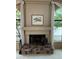 Living room with fireplace, with stone hearth and framed art above the mantle at 8243 E Cortez Dr, Scottsdale, AZ 85260