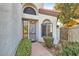 A secure gate door and arched window highlights the entry to this home with terracotta walkway at 8243 E Cortez Dr, Scottsdale, AZ 85260