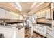 Bright kitchen with modern appliances, white cabinetry, and ample counter space at 8243 E Cortez Dr, Scottsdale, AZ 85260