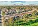 An aerial view of the neighborhood featuring desert homes with well-manicured landscaping and mountain views at 8334 E Jenan Dr, Scottsdale, AZ 85260