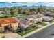 Scenic aerial shot showcasing homes with landscaping, mountain views, and a golf course nearby at 8334 E Jenan Dr, Scottsdale, AZ 85260